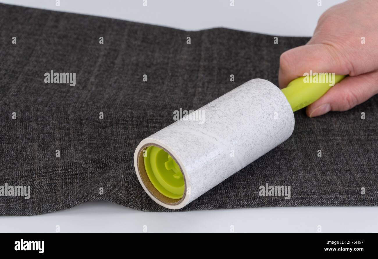 reusable sticky roller for cleaning clothes. Designed to remove dust, wool, lint from any type of fabric Stock Photo