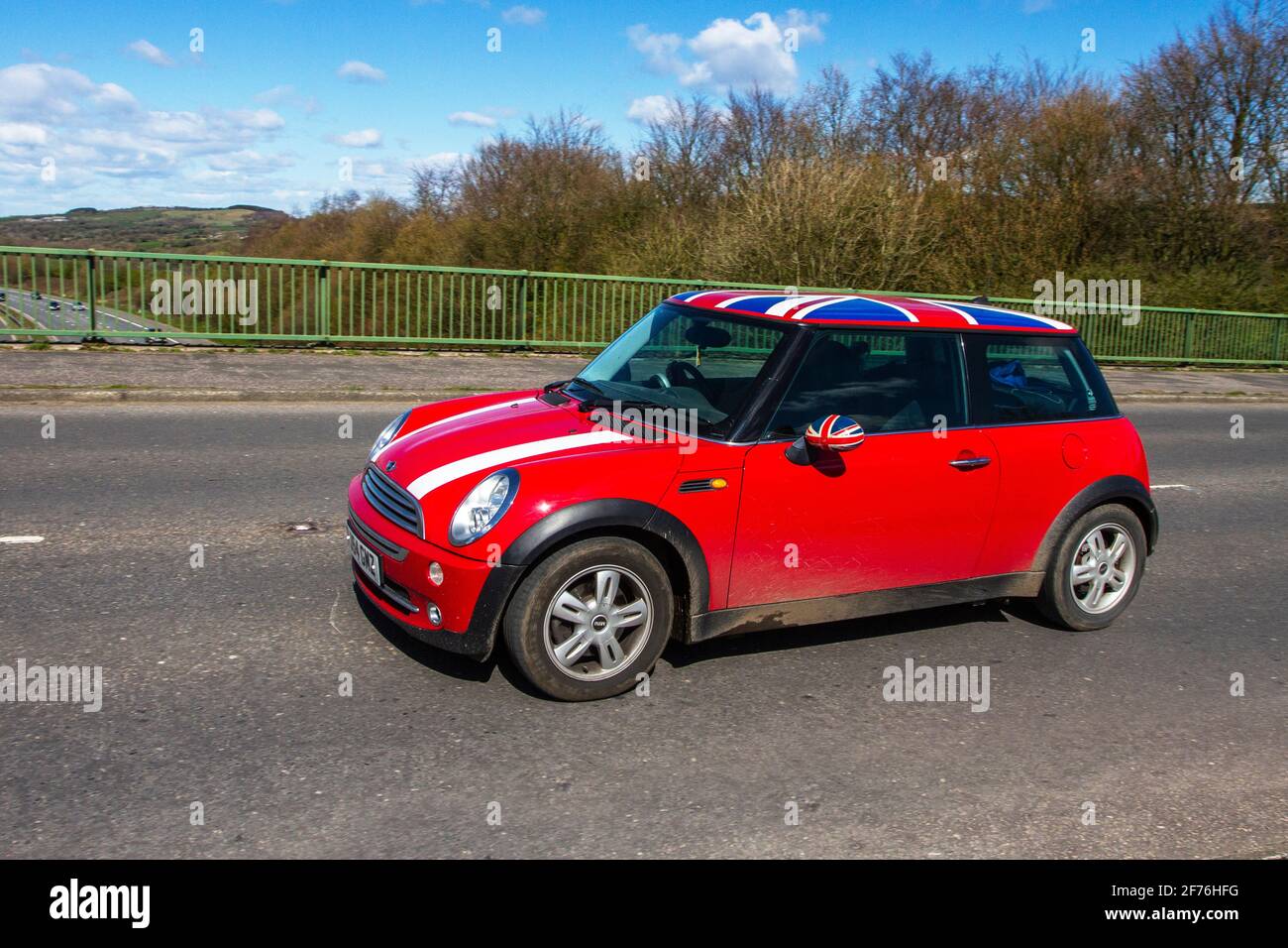 A Red Mini Cooper wth a Union Jack Roof by John Cooper version of