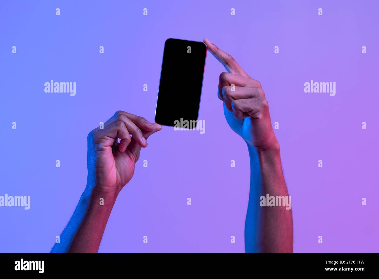 Two African American Male Hands Holding Smartphone With Black Screen, Mockup Image Stock Photo