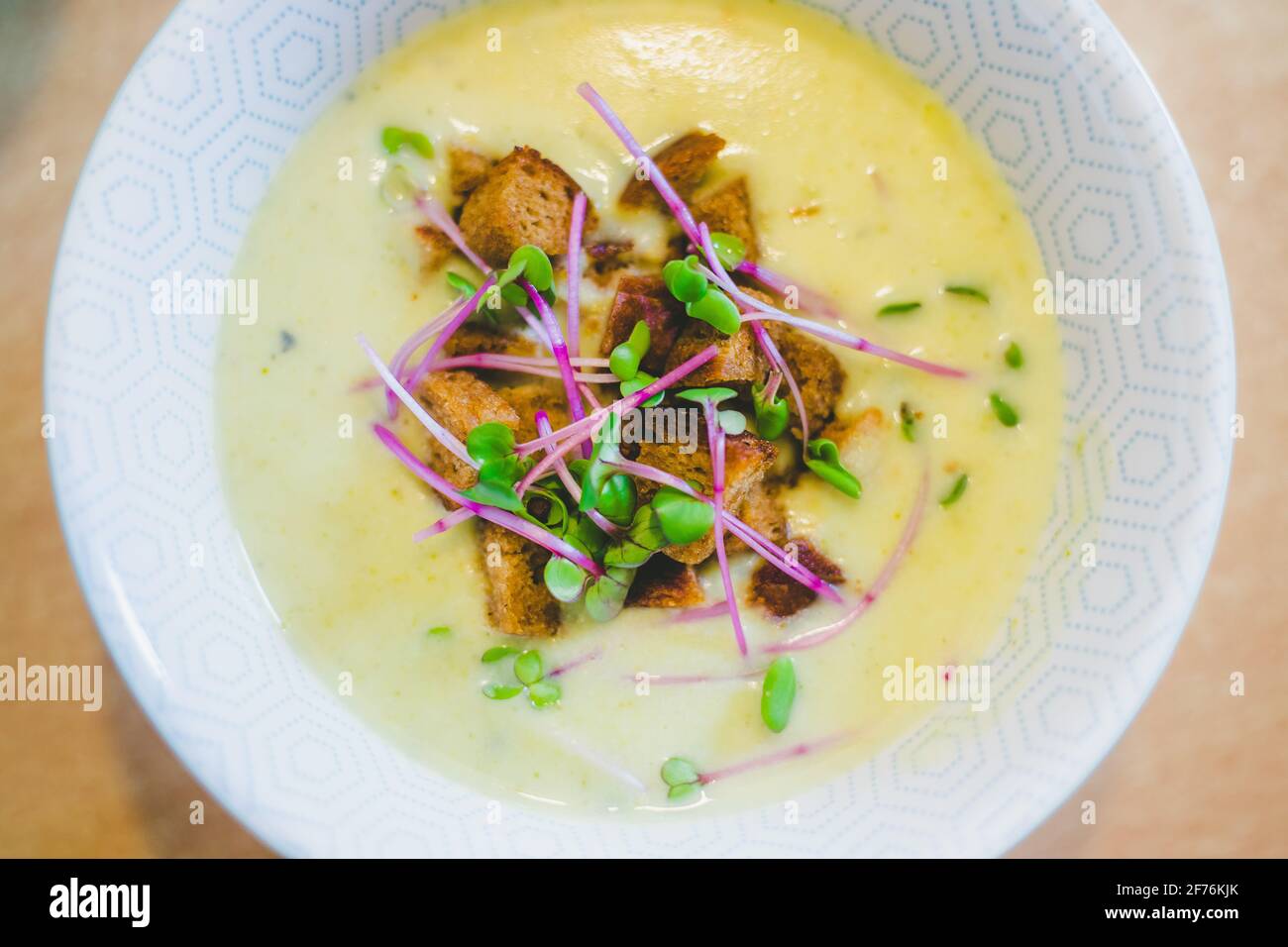 Close up of fresh broccoli soup with crunchy croutons and radish ...