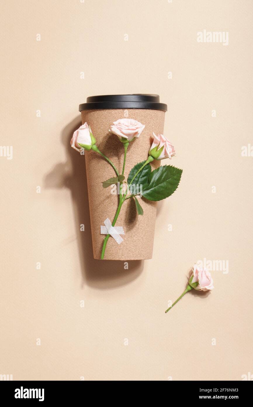 reusable eco coffee or tea cup with branch of roses on beige background. Sustainable lifestyle. Eco friendly and Zero waste concept.Flat lay  Stock Photo