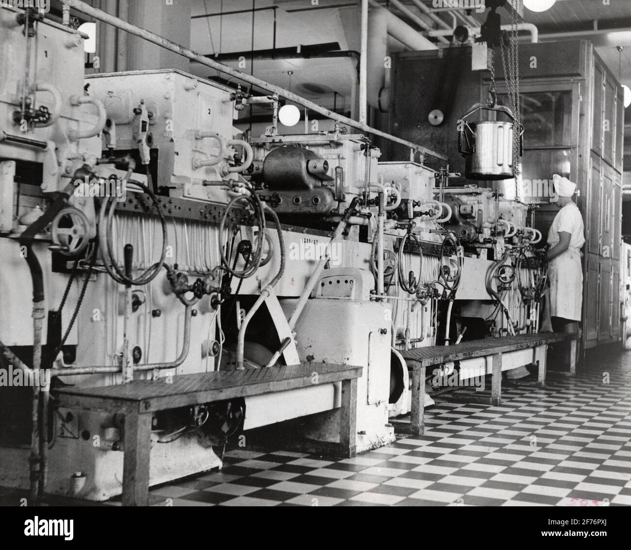 AB Cloetta, Ljungsbro, Interior. Filled chocolate with liquid fillings is manufactured in this facility. Here, the fillings are automatically sprayed into the chocolate shapes, which pass on a conveyor belt under the casting machines. Stock Photo