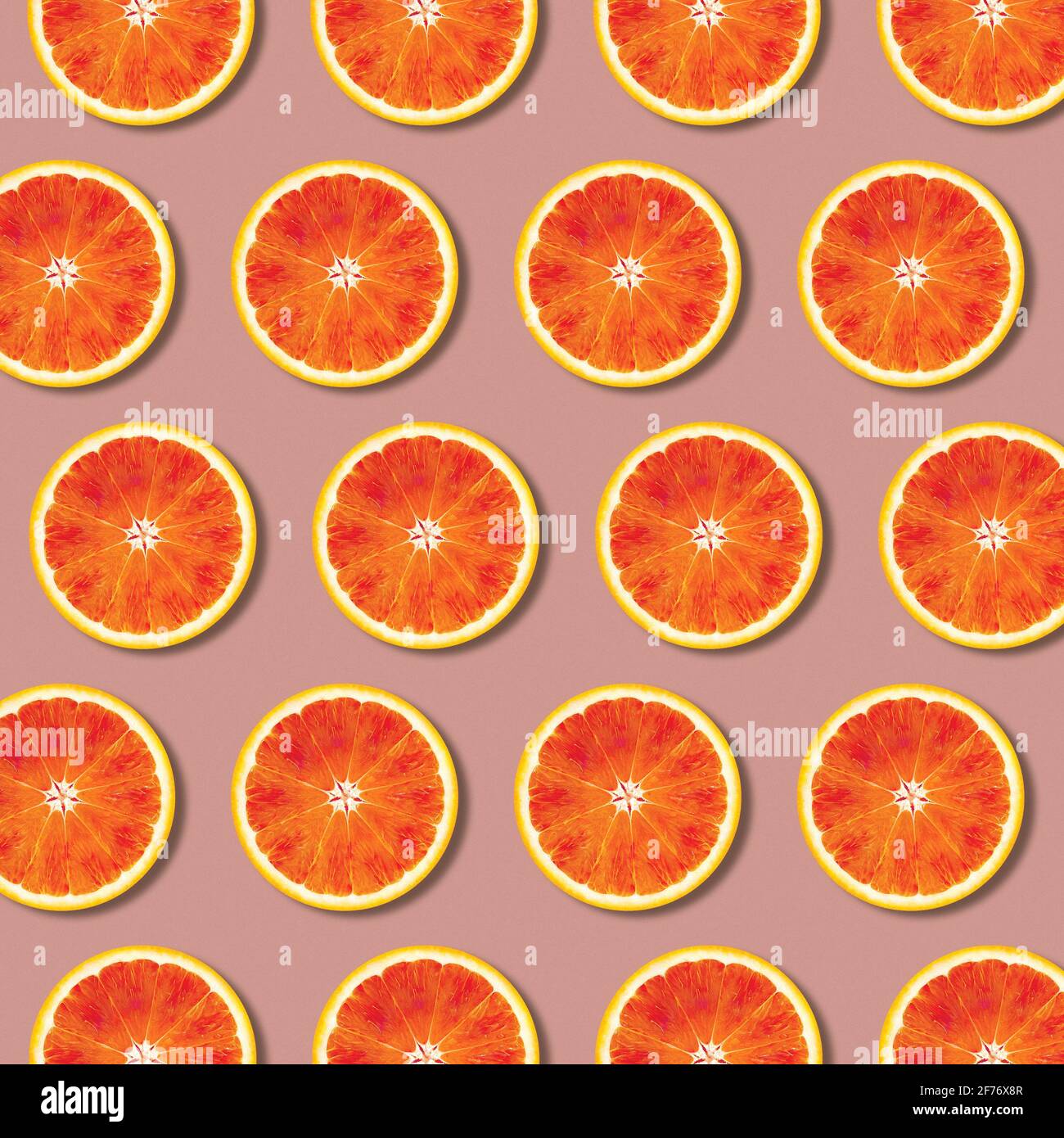 Geometric red orange fruit slices pattern, minimal flat lay food texture Stock Photo