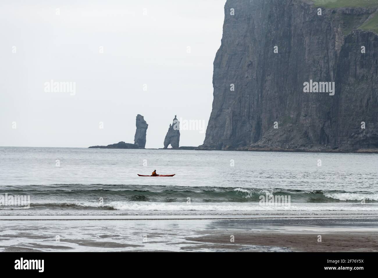 Lonely kayaker on Tjornuvik beach on Streymoy island, Faroe Islands, Denmark. Landscape photography Stock Photo