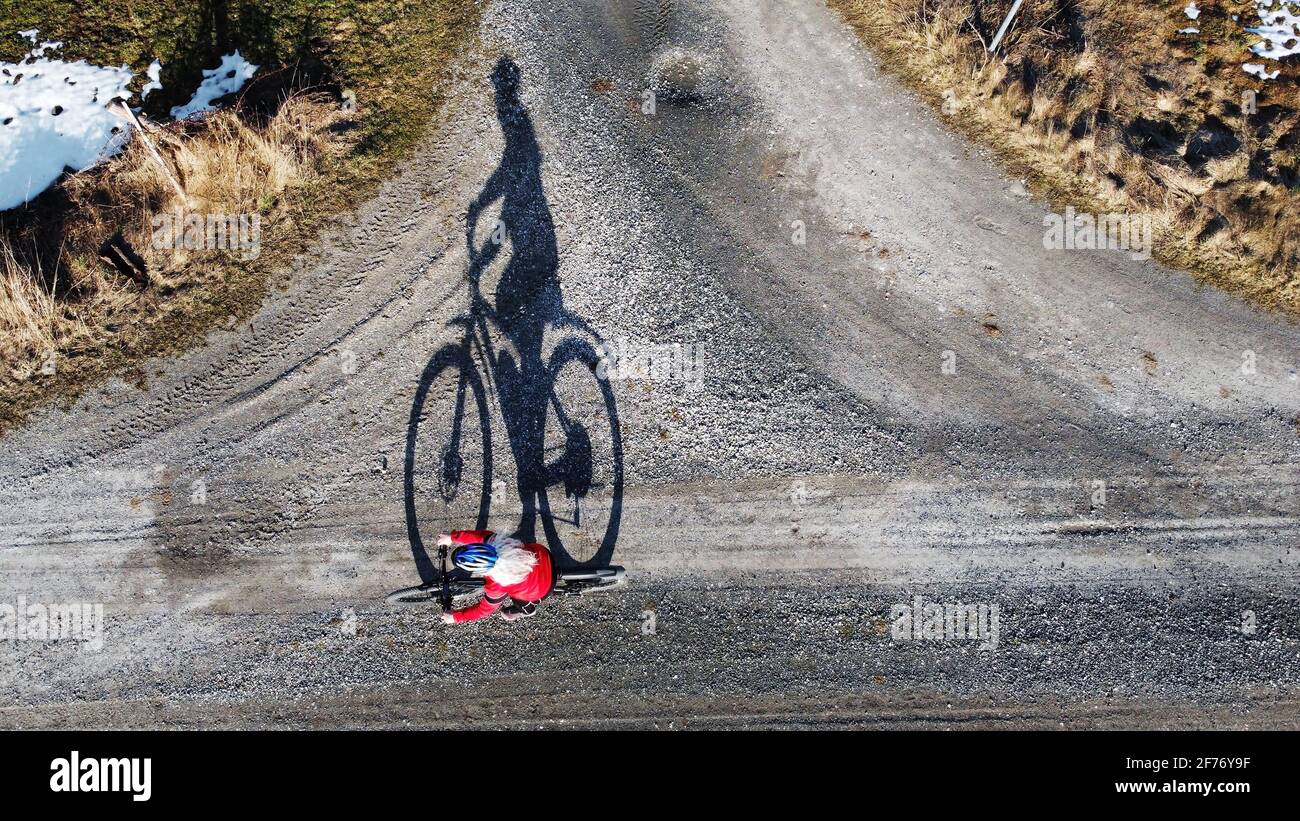 Aerial shot with drone of female cyclist on road with shadow Stock Photo -  Alamy