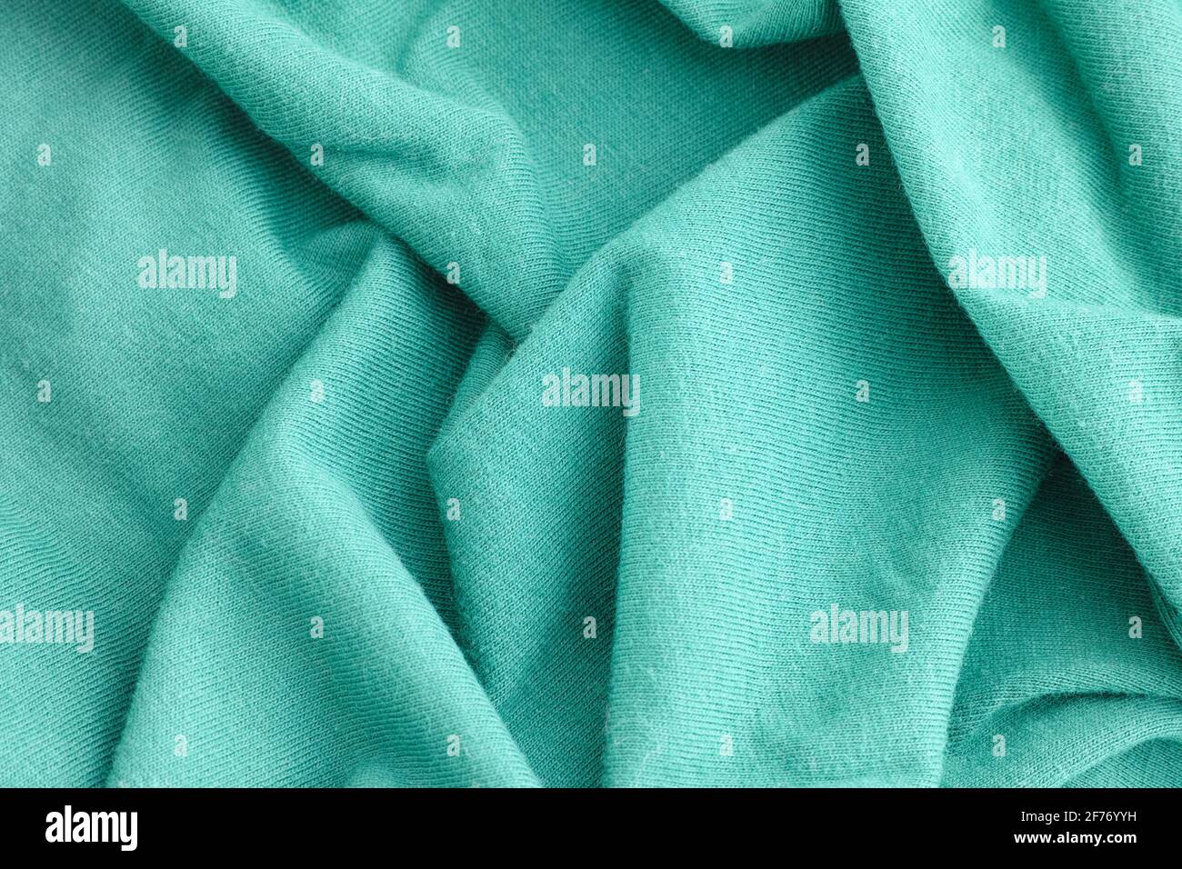 Cyan crumpled fabric texture background. Close up. Stock Photo