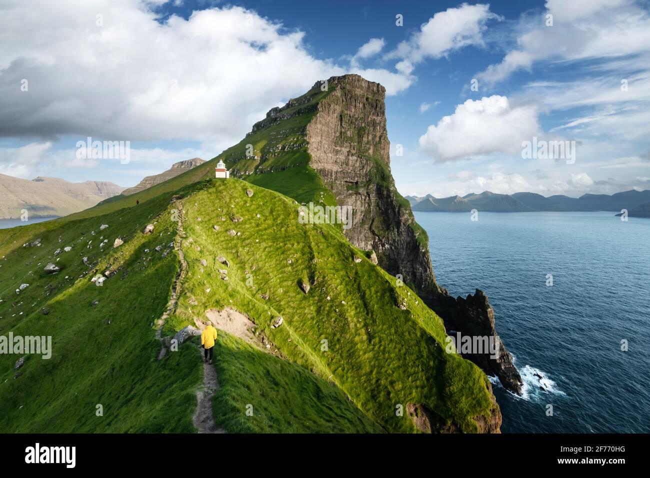 Kallur lighthouse on green hills of Kalsoy island, Faroe islands, Denmark. Landscape photography Stock Photo