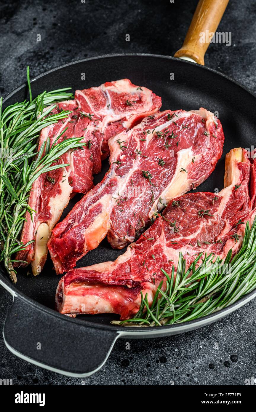 Raw top sirloin cap or picanha steak. Black background. Top view Stock