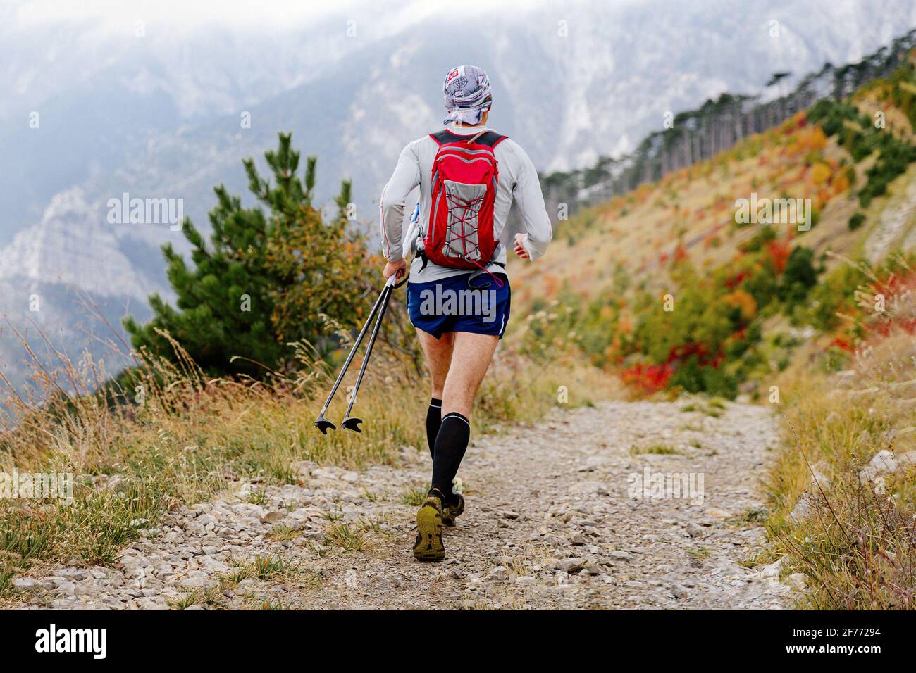 Man runner trekking poles hi-res stock photography and images - Alamy