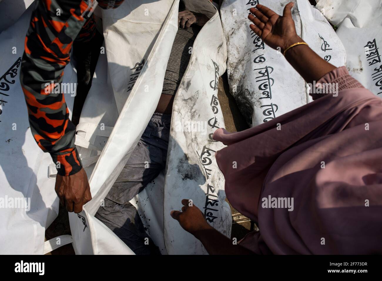 (EDITORS NOTE: Image depicts death)A woman identifies the dead body of her relative who got killed in the boat crush at Shitalakshya River. A Bangladeshi ferry capsized after colliding with a cargo vessel on Sunday in Shitalakkhya river south of the capital Dhaka, leaving at least 26 people dead and a few still missing. Stock Photo