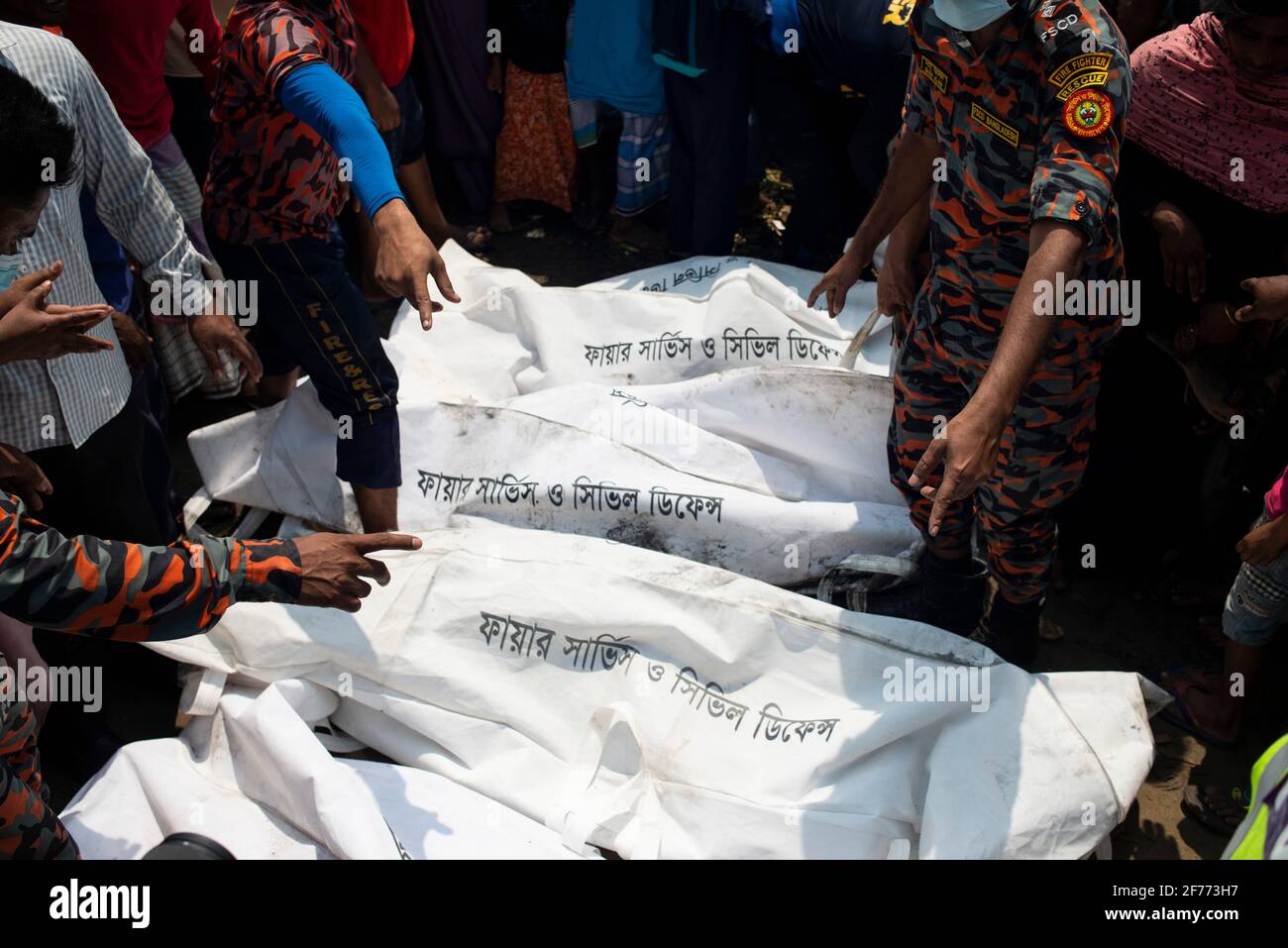 (EDITORS NOTE: Image depicts death)People seen pointing at the different body bags as they identify the bodies of their relative who died in the boat crush at Shitalakshya River. A Bangladeshi ferry capsized after colliding with a cargo vessel on Sunday in Shitalakkhya river south of the capital Dhaka, leaving at least 26 people dead and a few still missing. Stock Photo