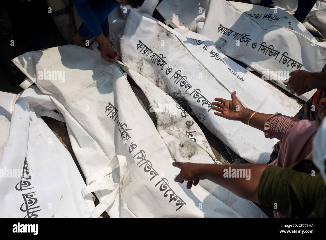 (EDITORS NOTE: Image depicts death)People seen pointing at the different body bags as they identify the bodies of their relative who died in the boat crush at Shitalakshya River. A Bangladeshi ferry capsized after colliding with a cargo vessel on Sunday in Shitalakkhya river south of the capital Dhaka, leaving at least 26 people dead and a few still missing. Stock Photo