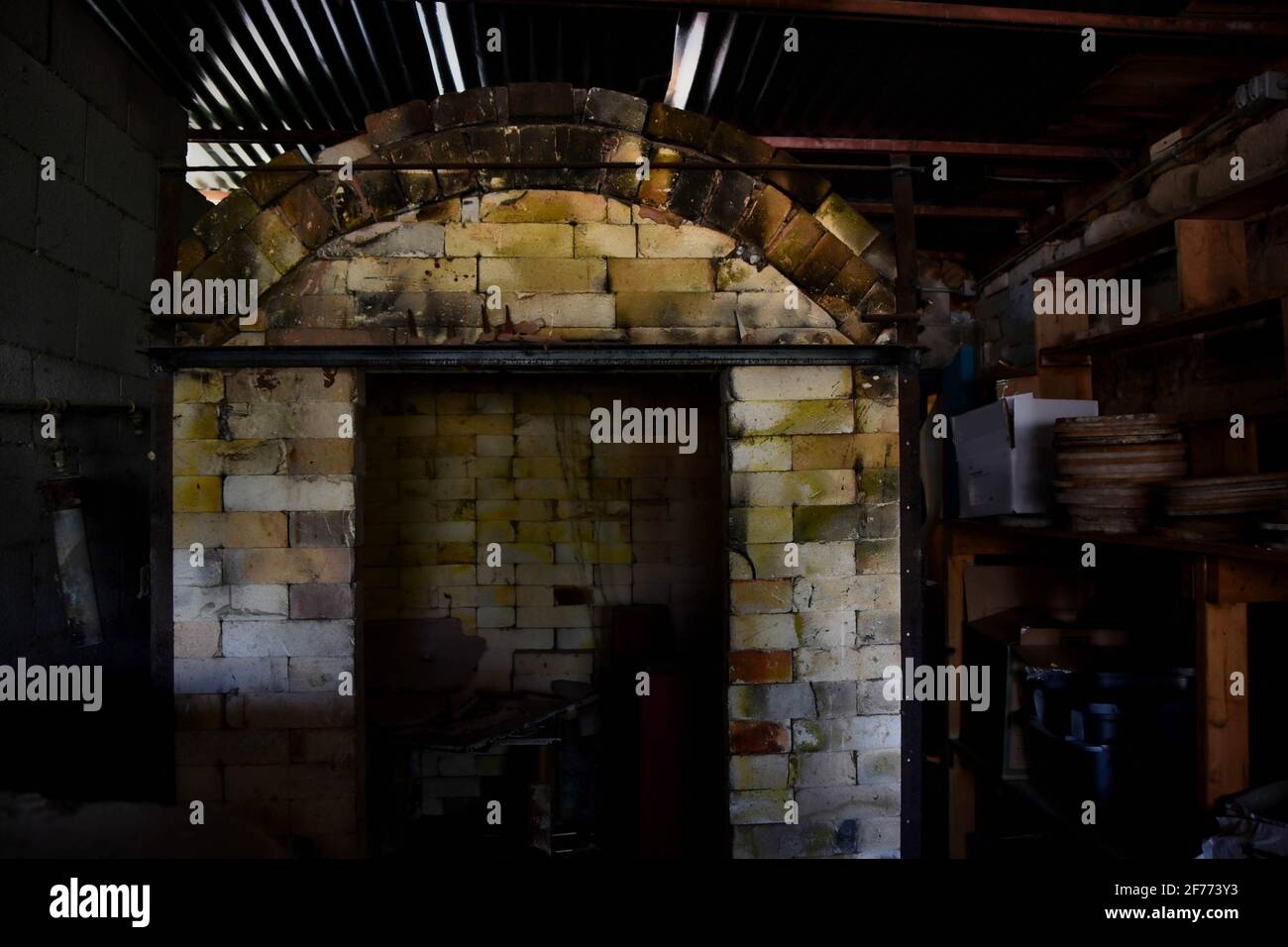 Abandoned pottery shed, looking into a kiln. Creepy empty building. Stock Photo