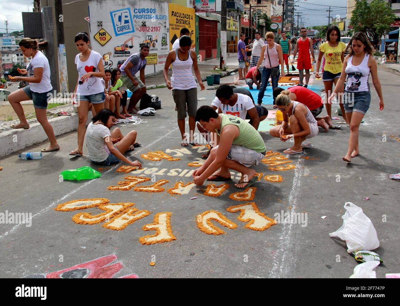 Itabuna, Bahia / Brazil - June 7, 2012: People are seen making traditional tapes during the Corpus Crist holiday festivities in Itabuna. *** Local Cap Stock Photo