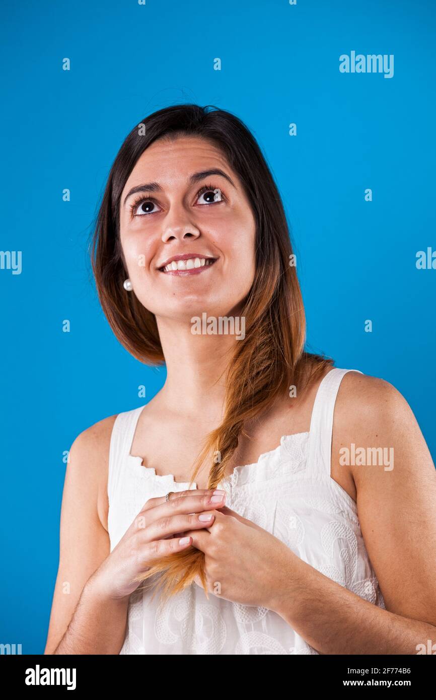 Beautiful young woman in a blue background Stock Photo