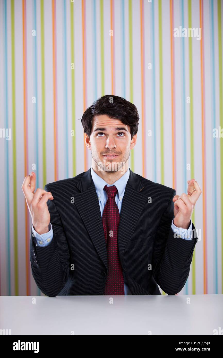 Businessman with cross fingers Stock Photo