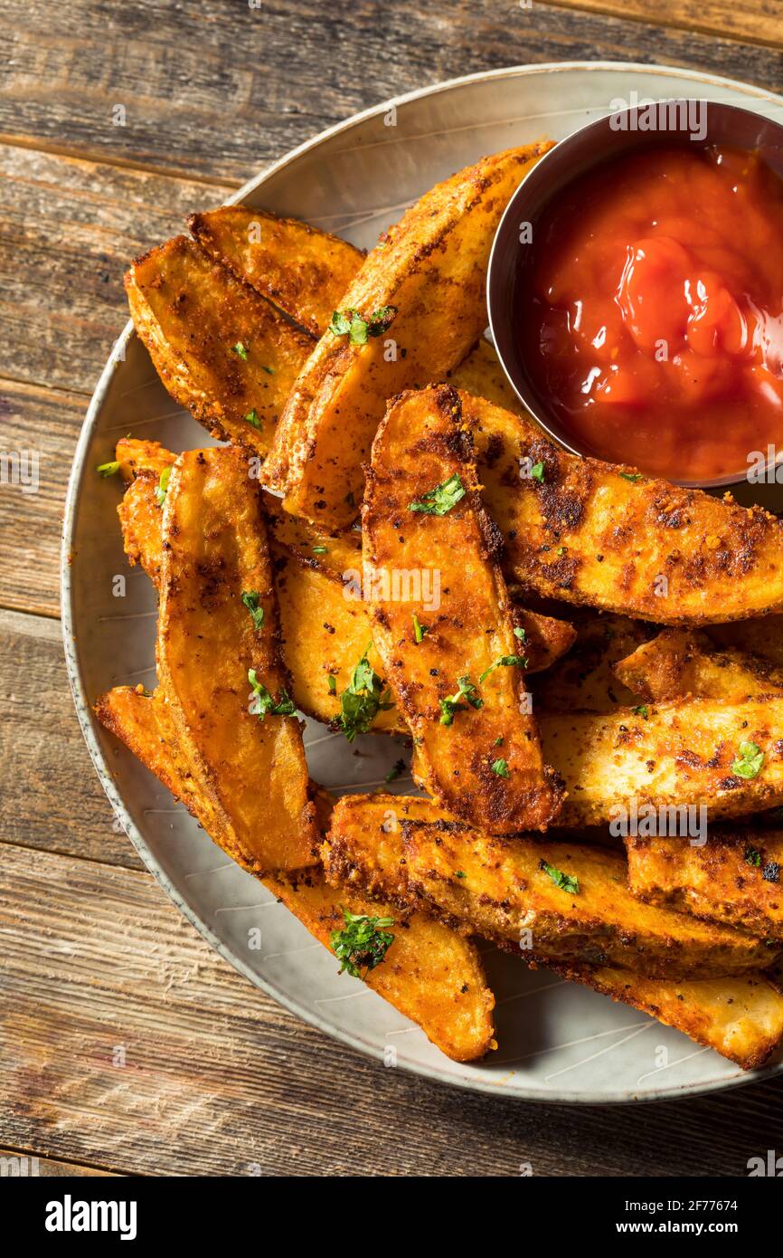 Homemade Spicy Oven Fried Potato Wedges with Ketchup Stock Photo Alamy