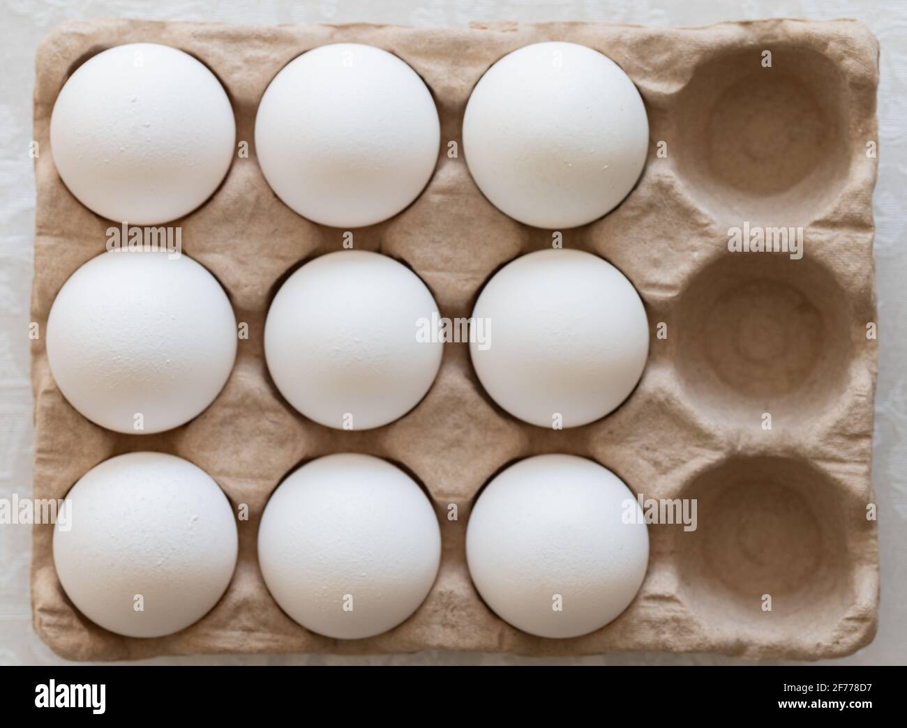 Carton of Eggs with Three Missing Stock Photo
