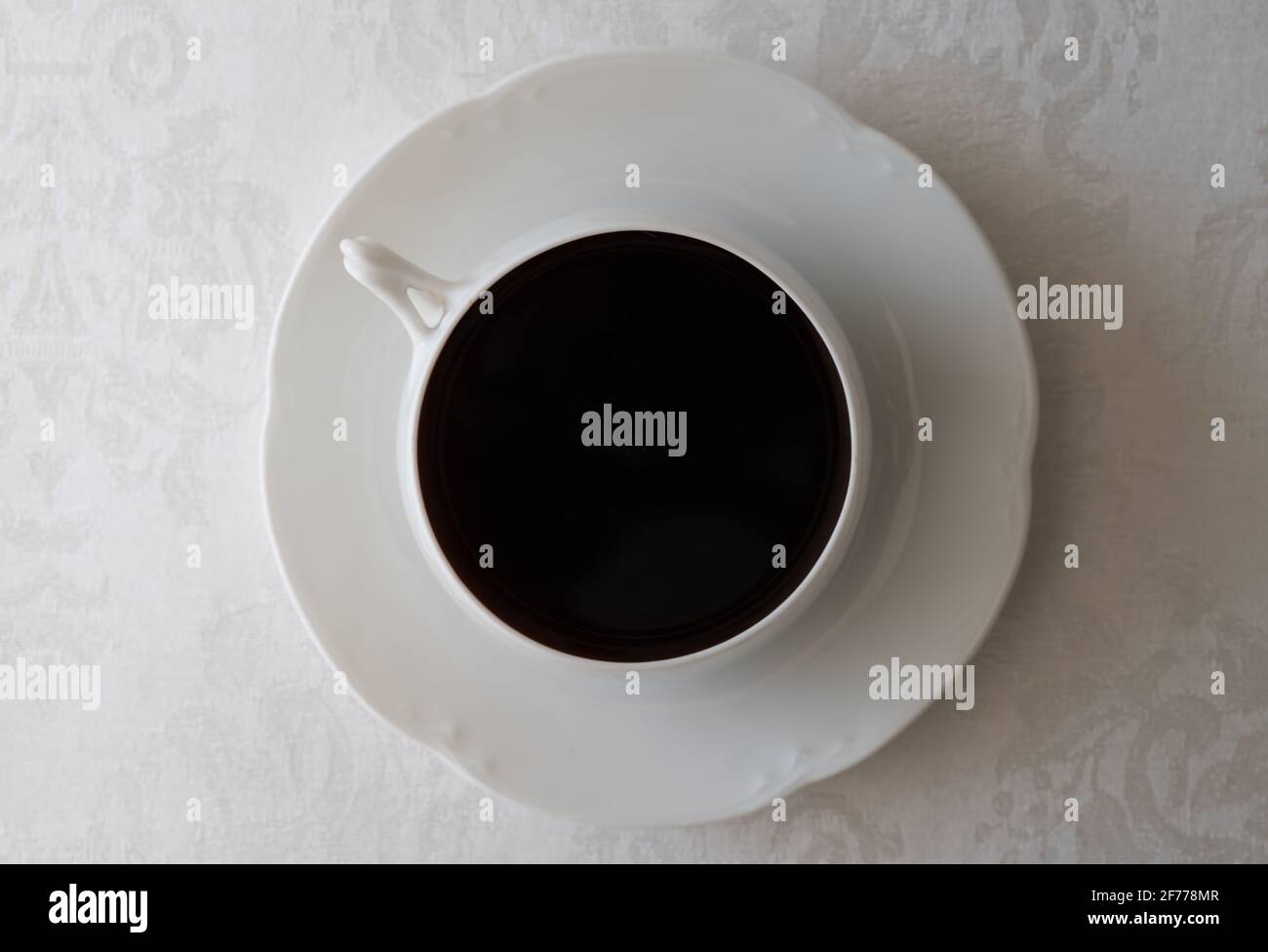Coffee in White Mug on White Tablecloth Stock Photo