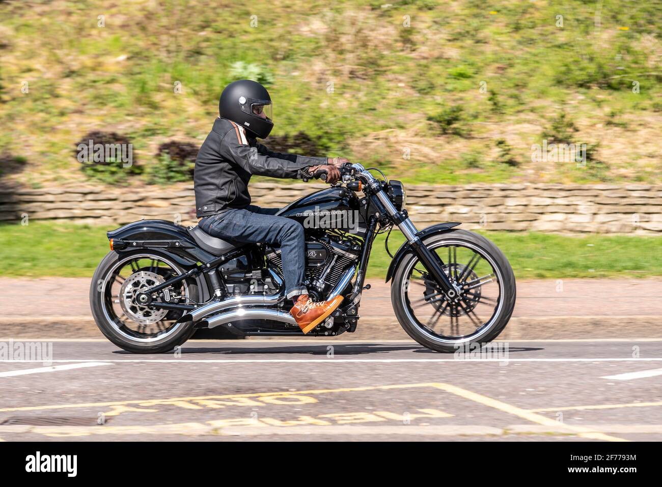 Harley Davidson 114 cubic inch motorcycle rider, riding in Southend on Sea, Essex, UK, passing Cliff Gardens green space on Western Esplanade Stock Photo