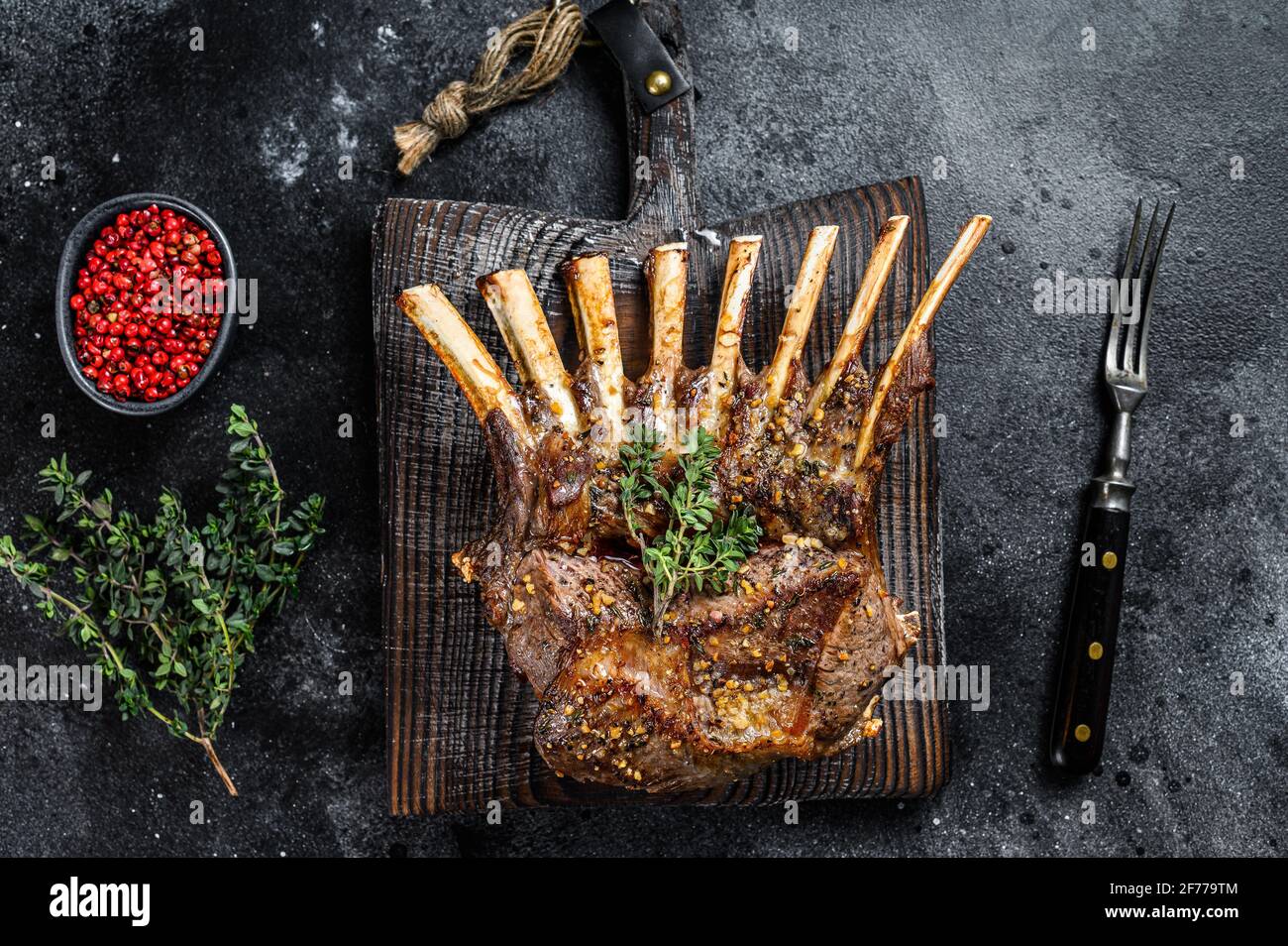Barbecue rack of lamb meat chops. Black background. Top view Stock