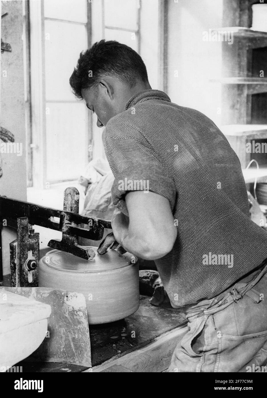 Gustavsberg's porcelain factory. Turning of plate Stock Photo Alamy