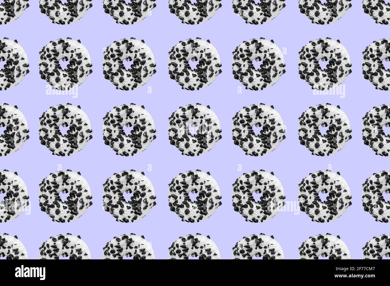 Pattern made with black and white cookie donut on blue background Stock Photo