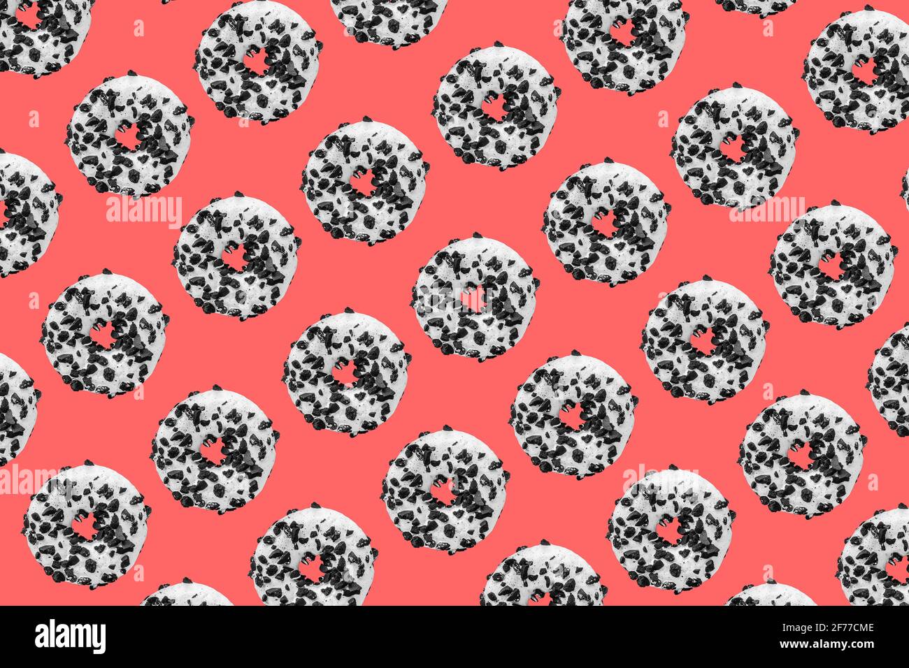 Pattern made with black and white cookie donut on red background Stock Photo