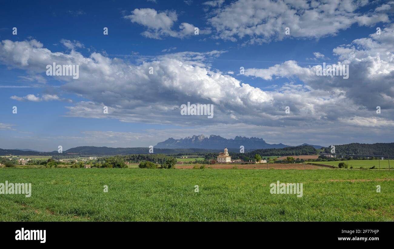 Montserrat mountain and Torre Lluvià tower, in Manresa and Pla de Bages, in a spring afternoon (Barcelona province, Catalonia, Spain) Stock Photo