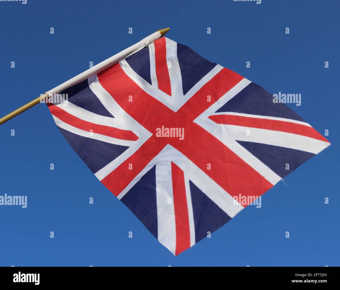 Union Jack flying, flag of the UK flying over a blue sky Stock Photo ...