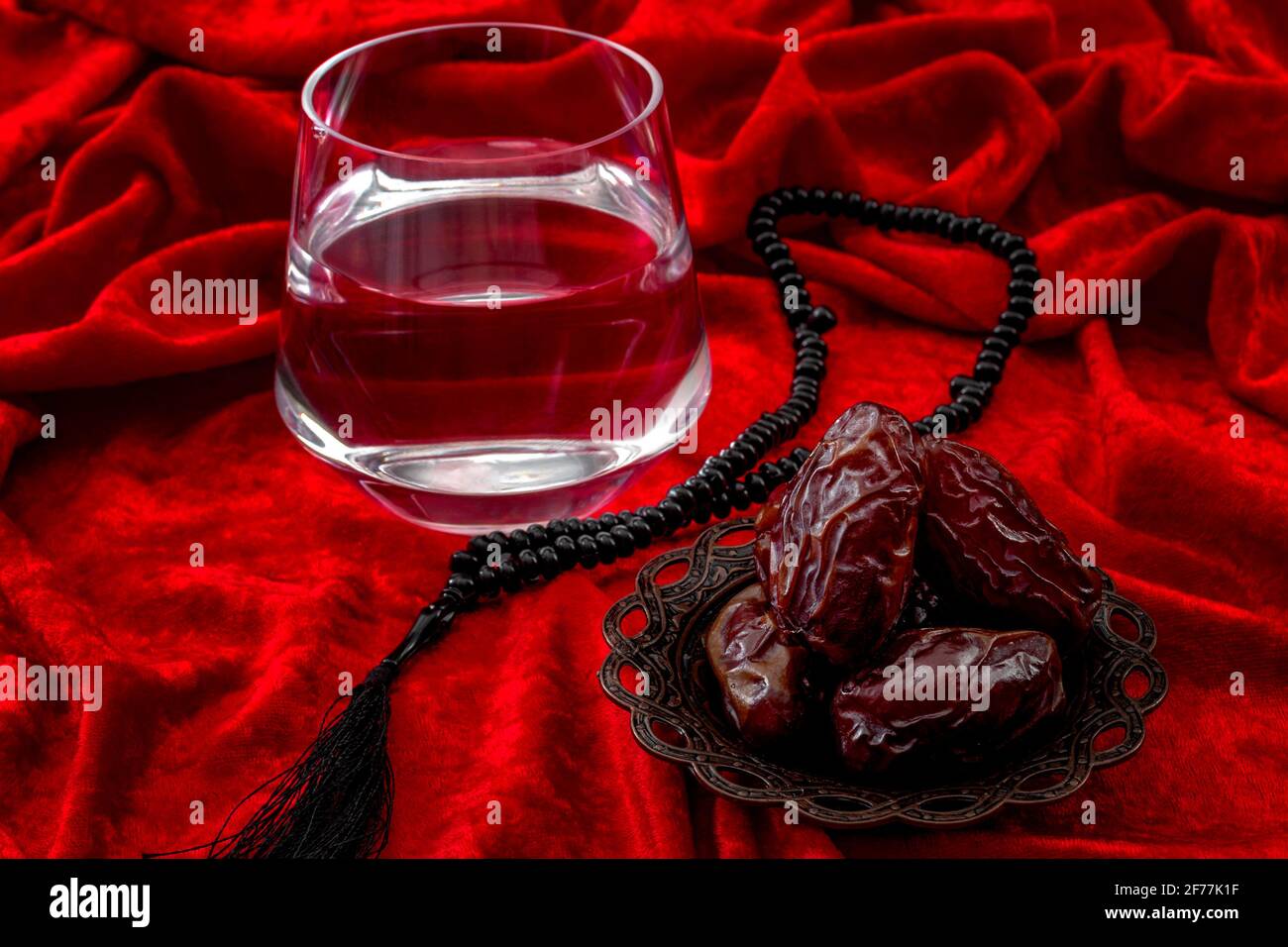 Muslim religious tradition, Ramadan month, Islam and break of the fast after sunset or Iftar concept theme with close up on a bowl of dried dates, pra Stock Photo