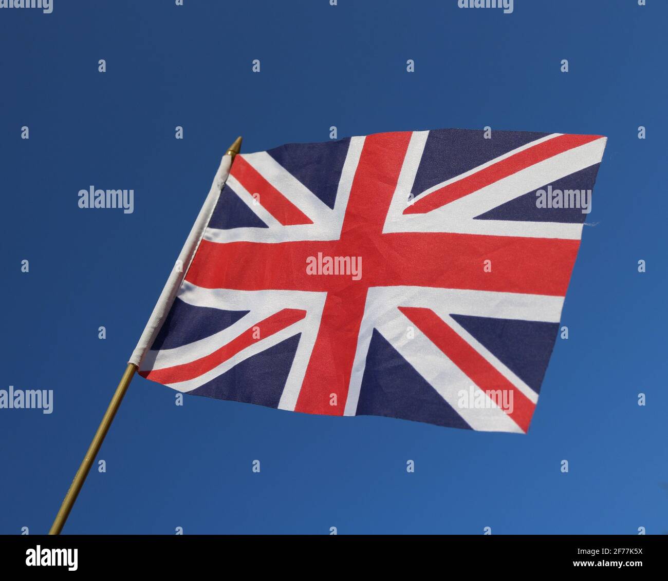 Union Jack flying, flag of the UK flying over a blue sky Stock Photo ...