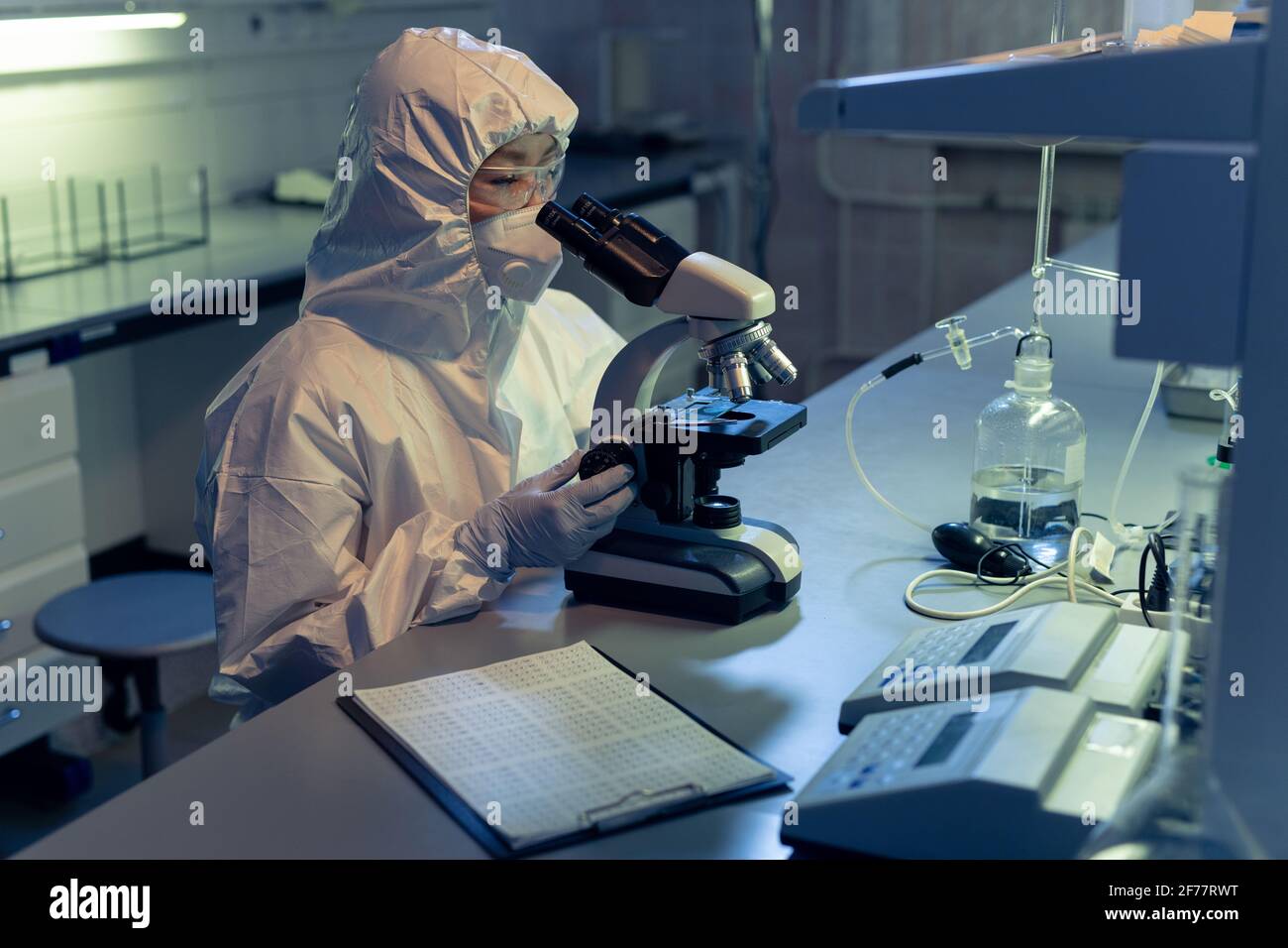 Examining Microscope Doctor examining samples through microscope hi-res stock photography ...