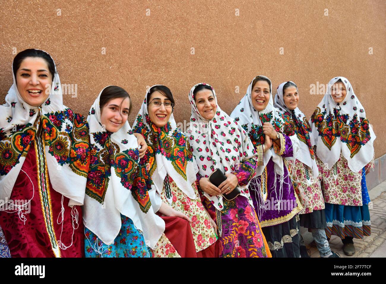Iran, Isfahan province, Abyaneh, Cheerful visitors wearing the traditional village dress Stock Photo