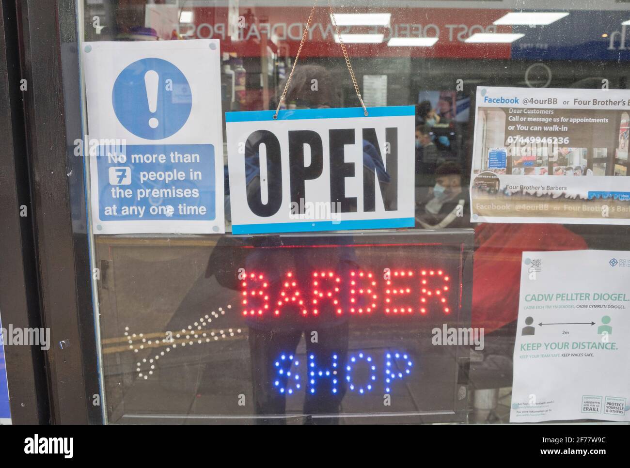 Barber and hairdresser shop reopened after lifting of lockdown restrictions due to the Coronavirus pandemic in Aberystwyth, Ceredigion, Wales, UK. Stock Photo
