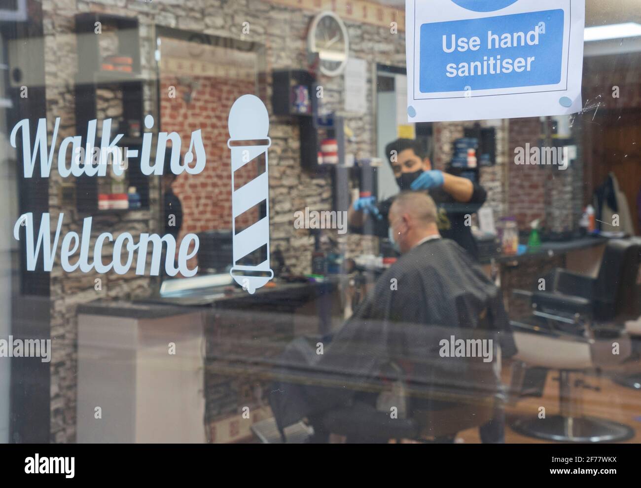 Barber and hairdresser shop reopened after lifting of lockdown restrictions due to the Coronavirus pandemic in Aberystwyth, Ceredigion, Wales, UK. Stock Photo