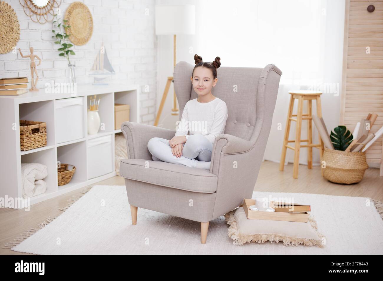 cute preteen girl sitting in bright living room at home Stock Photo - Alamy