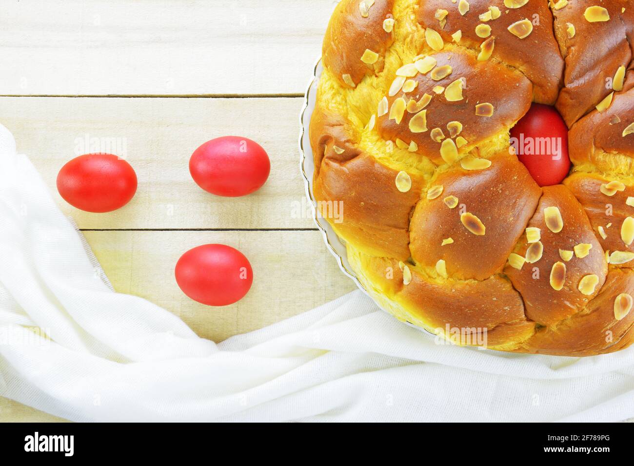Easter candle,Easter red eggs and Easter bread on wooden table Stock Photo