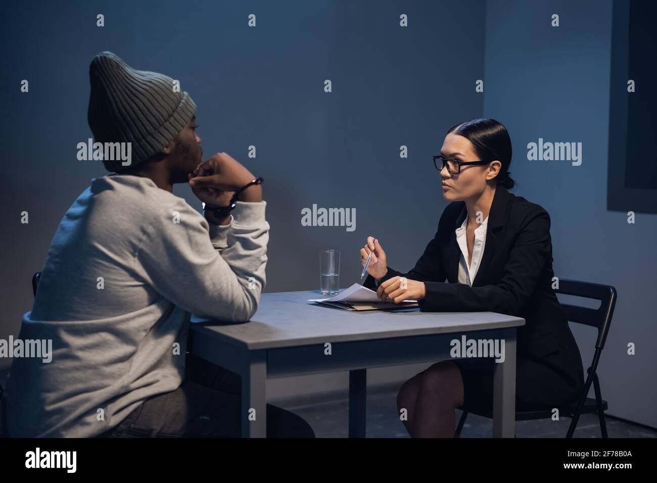 A lawyer girl with glasses and a young black guy communicate in the