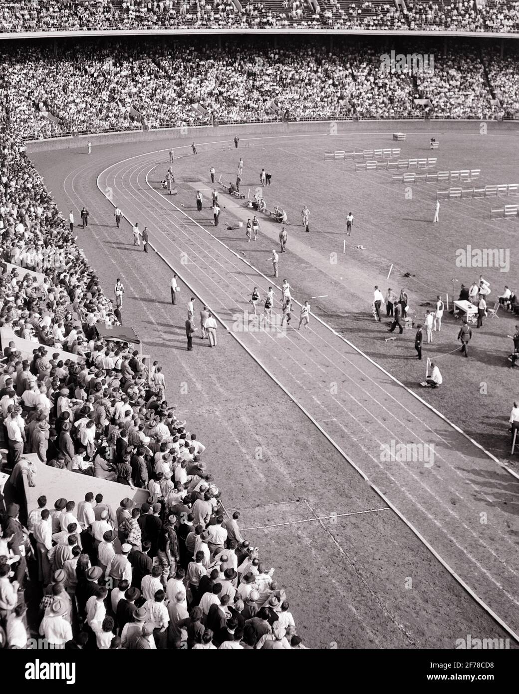 1950s 1956 PENN RELAYS ANNUAL TRACK AND FIELD ATHLETIC COMPETITION FRANKLIN FIELD UNIVERSITY OF PENNSYLVANIA PHILADELPHIA PA USA - s3608 HAR001 HARS PERSONS MALES TEENAGE BOY CARNIVAL SPECTATORS B&W GOALS SCHOOLS DREAMS WELLNESS HIGH ANGLE ADVENTURE STRENGTH UNIVERSITIES AND EXCITEMENT EXTERIOR PA PENN HIGH SCHOOL HIGH SCHOOLS HIGHER EDUCATION 1956 TEENAGED COLLEGES 1895 COOPERATION GROWTH JUVENILES MID-ADULT MID-ADULT MAN YOUNG ADULT MAN ANNUAL BLACK AND WHITE HAR001 LARGEST OLD FASHIONED OLDEST Stock Photo