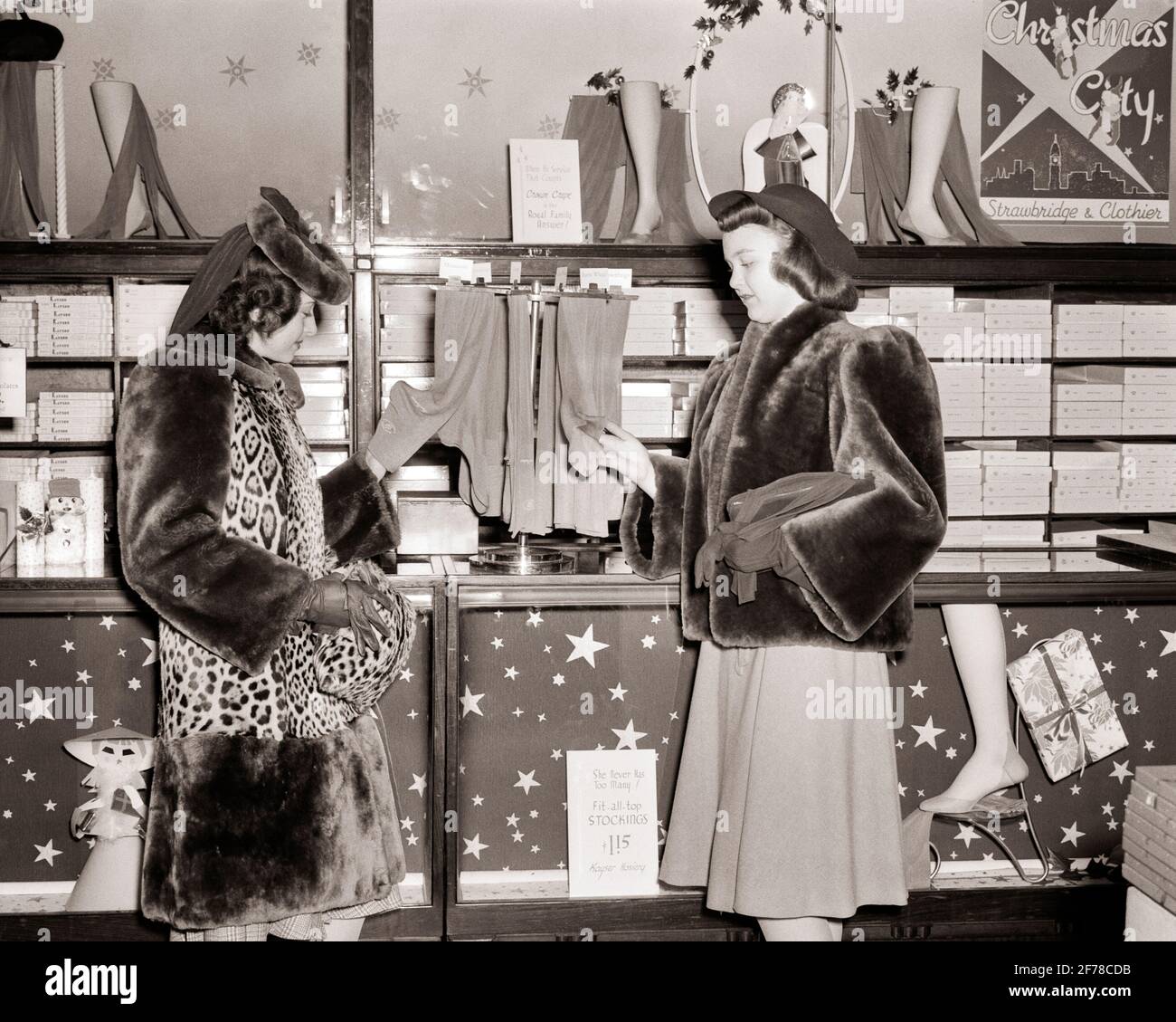 1940s TWO WELL DRESSED WOMEN CHRISTMAS DEPARTMENT STORE SHOPPING FOR SILK STOCKINGS WEARING FUR COATS HATS PHILADELPHIA PA USA - s5795 HAR001 HARS STYLE FRIEND LEOPARD WEALTHY DEPARTMENT DECORATIONS RICH LIFESTYLE FEMALES COATS LUXURY FRIENDSHIP HALF-LENGTH LADIES PERSONS SHOPS SKIN B&W SHOPPER SHOPPERS DISCOVERY STYLES AND PA STORES UPSCALE HOSIERY NYLONS AFFLUENT FRIENDLY STYLISH CLOTHIER COMMERCE FASHIONS FURS MID-ADULT MID-ADULT WOMAN STRAWBRIDGE WELL-TO-DO BLACK AND WHITE BUSINESSES CAUCASIAN ETHNICITY HAR001 OLD FASHIONED Stock Photo