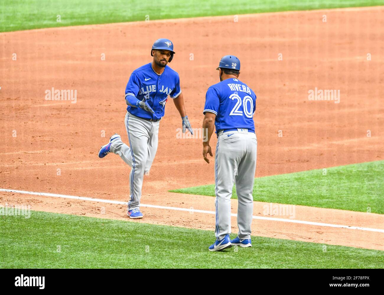 Apr 10, 2021: Toronto Blue Jays shortstop Marcus Semien #10 shakes hands with third base coach Luis Rivera #20 as he rounds third base after hitting a two run home run in the top of the second inning during an Opening Day MLB game between the Toronto Blue Jays and the Texas Rangers at Globe Life Field in Arlington, TX Albert Pena/CSM Stock Photo