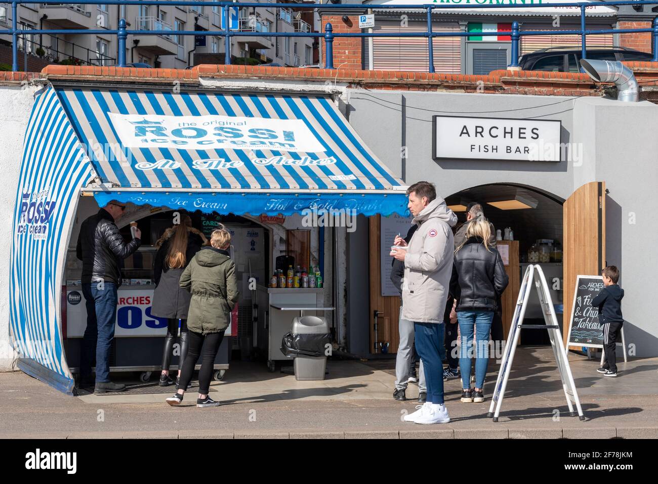 People at Rossi ice cream stall and Arches fish bar of The Arches in Southend on Sea, Essex, UK. Customers for takeaway bars during COVID 19 lockdown Stock Photo