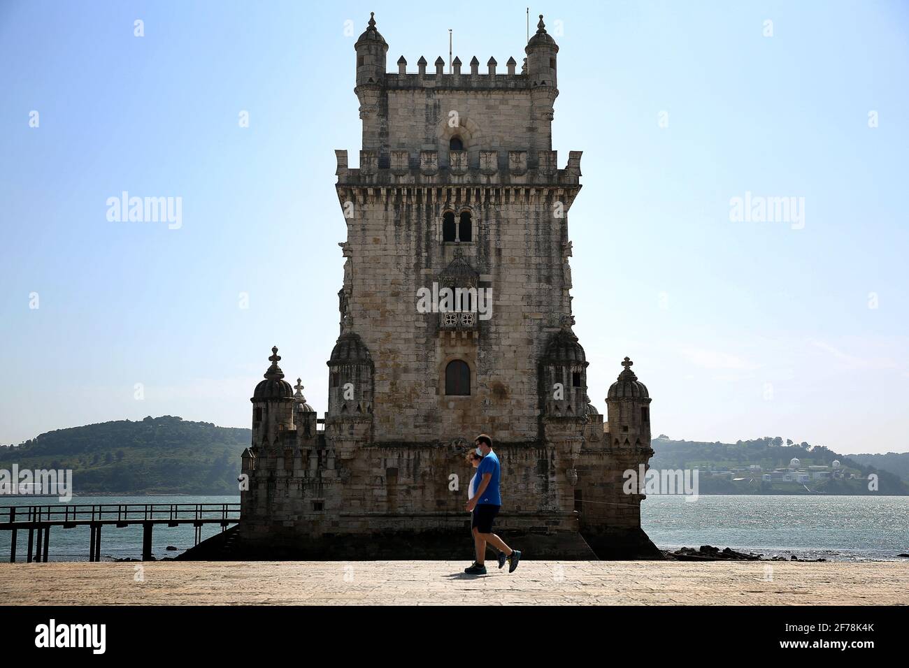 Lisbon, Portugal. 5th Apr, 2021. People wearing face masks walk past the Belem Tower in Lisbon