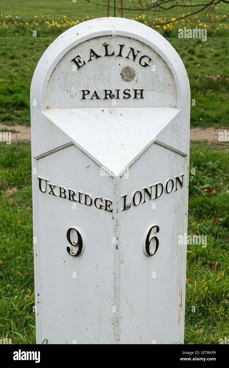 An old white Ealing Parish milestone, milepost on the Uxbridge Road dated 1832, London, England United Kingdom UK Stock Photo