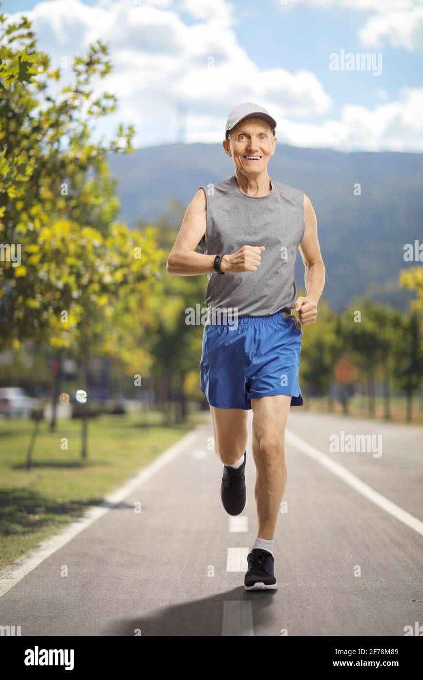 Full length portrait of an elderly man running on a track Stock Photo