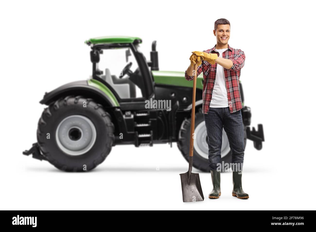 Full length portrait of a young farmer standing with a shovel in front ...