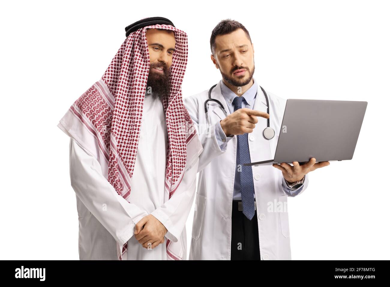 Serious doctor showing a laptop computer to a saudi arab man isolated on white background Stock Photo