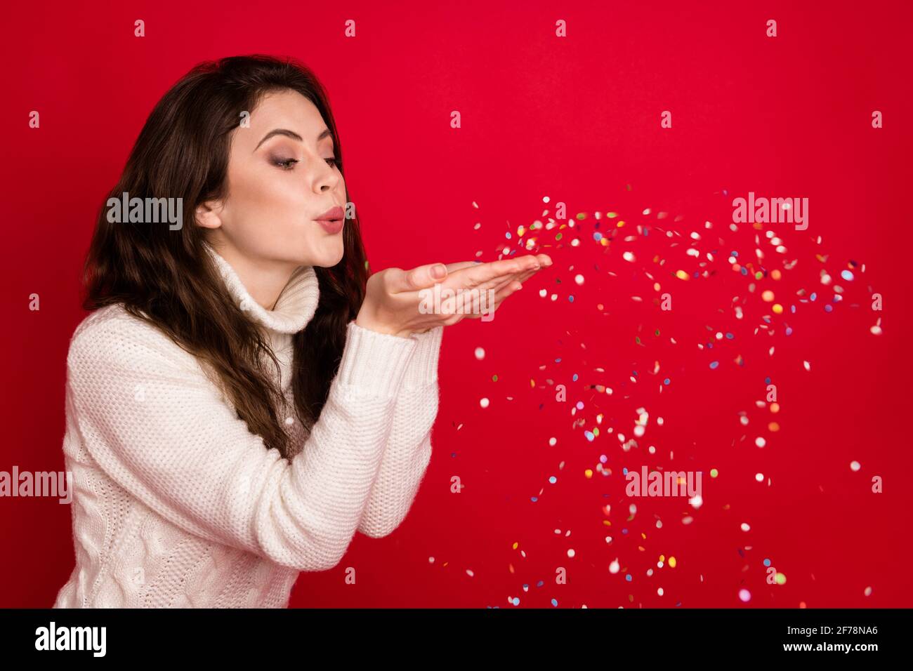 Photo of pretty adorable young lady wear collar pullover blowing arms glitter isolated red color background Stock Photo