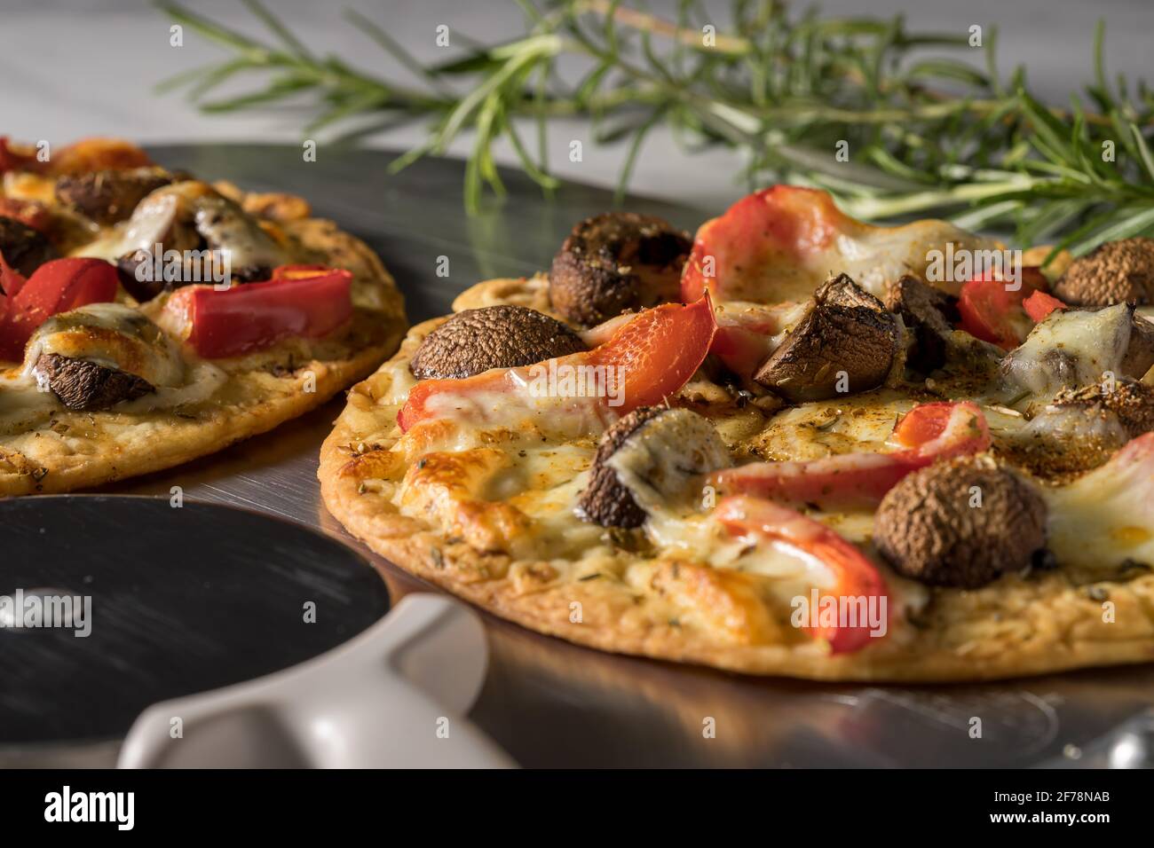 Vegetarian pita pizza. Flatbread with mushrooms, mozzarella cheese and red peppers. Stock Photo